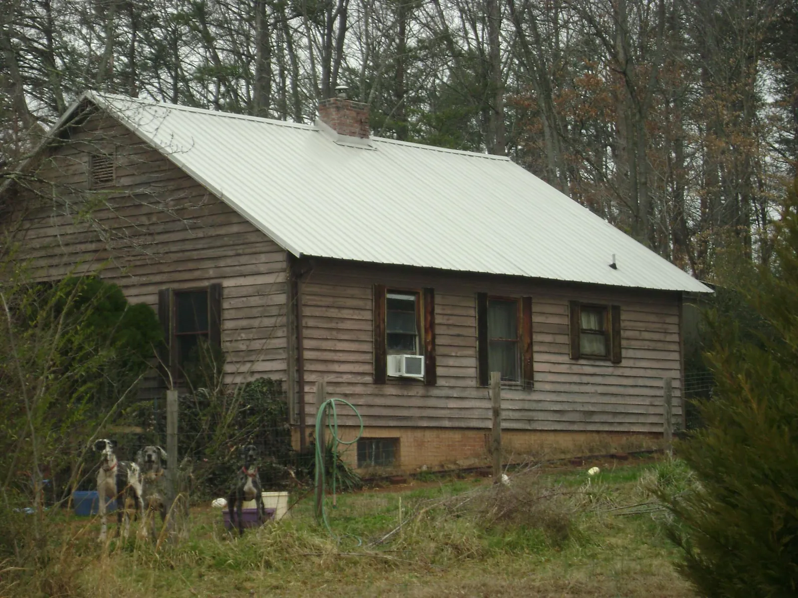 White metal roof on an old wood sided farmhouse, from a Metal Roof Installation job in Kingman